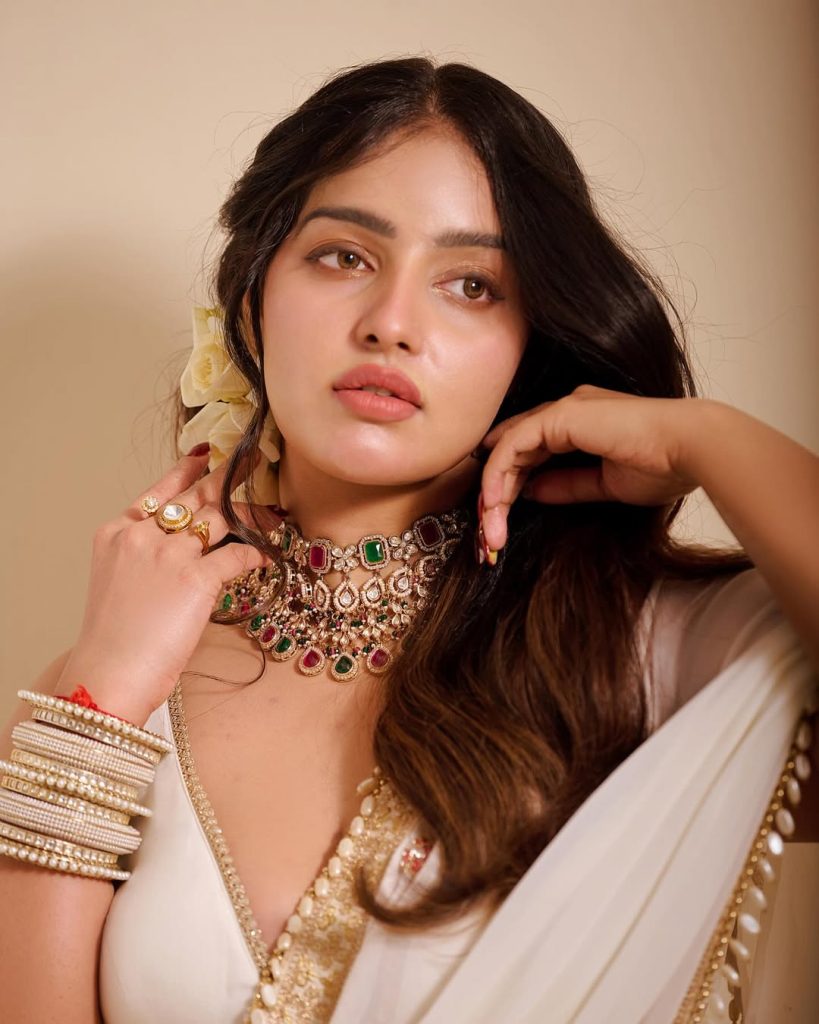 Official glamorous photoshoot of actress Malavika Menon in vibrant ethnic attire for 2026.