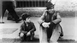 A classic scene from the movie Bicycle Thieves showing Antonio and his son Bruno searching for their bicycle in Rome.