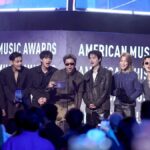 BTS Historic Win at AMAs 2026! — அமெரிக்காவில் மிரட்டிய BTS; 'ஆண்டின் சிறந்த கலைஞர்' உட்பட 3 மெகா விருதுகள் வென்று உலக சாதனை! 7 Global K-pop group BTS holding their three trophies, including Artist of the Year, at the American Music Awards 2026 stage in Las Vegas.